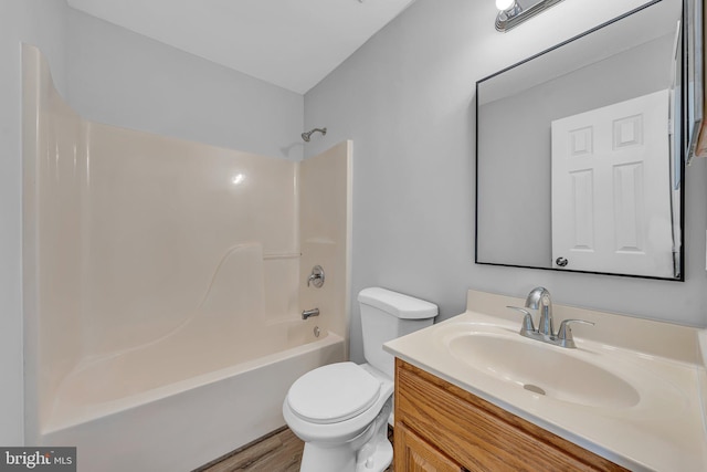 full bathroom featuring toilet, vanity, bathtub / shower combination, and hardwood / wood-style flooring