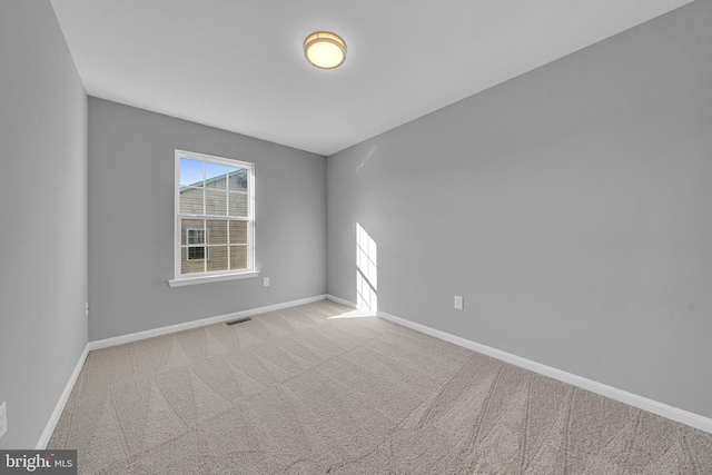 unfurnished room with light colored carpet