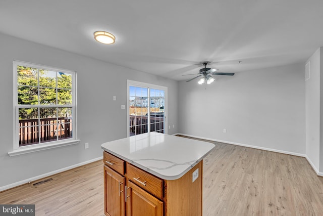 kitchen featuring light hardwood / wood-style floors, plenty of natural light, and ceiling fan