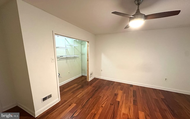 empty room with dark hardwood / wood-style floors and ceiling fan