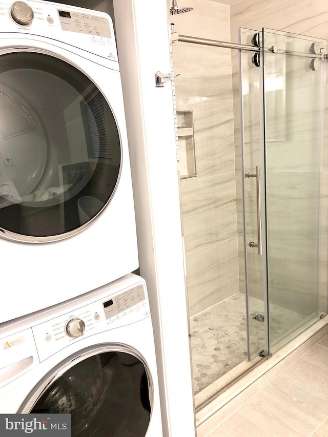 laundry area with stacked washer / dryer