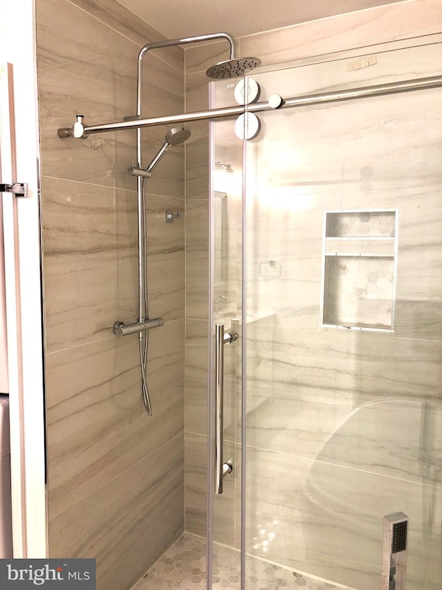 bathroom with a shower with shower door