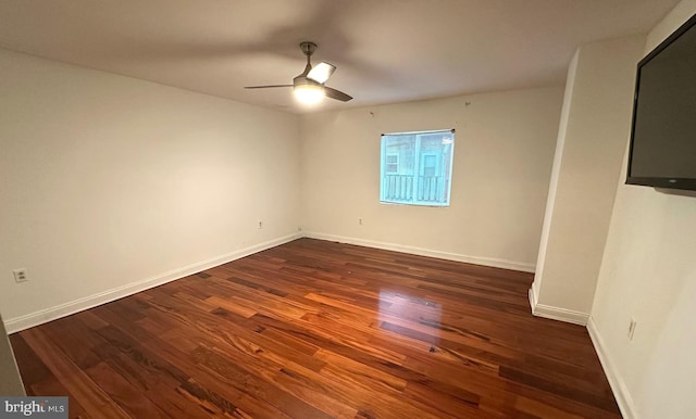 unfurnished room featuring ceiling fan and dark hardwood / wood-style flooring