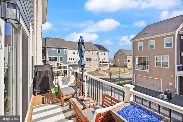 balcony featuring a residential view, central AC unit, and area for grilling