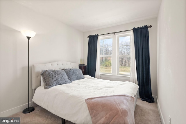 carpeted bedroom with baseboards