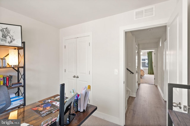 office space with visible vents, baseboards, and wood finished floors