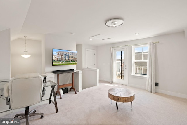 carpeted office space with vaulted ceiling and baseboards