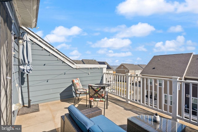 view of patio featuring a residential view and a balcony