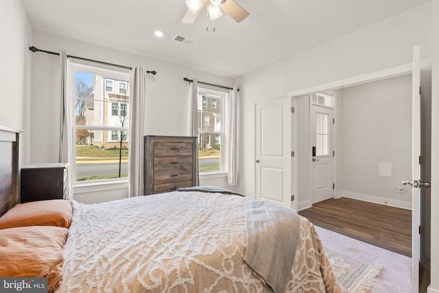 bedroom featuring ceiling fan, recessed lighting, wood finished floors, visible vents, and baseboards