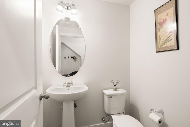 bathroom featuring toilet and a sink