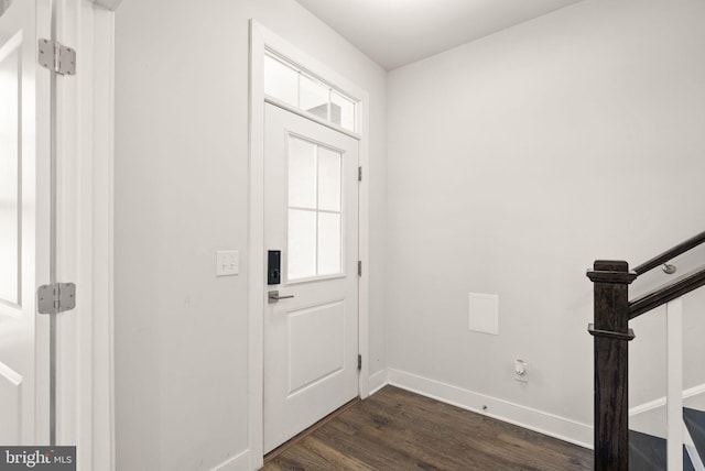 foyer featuring stairway, dark wood finished floors, and baseboards