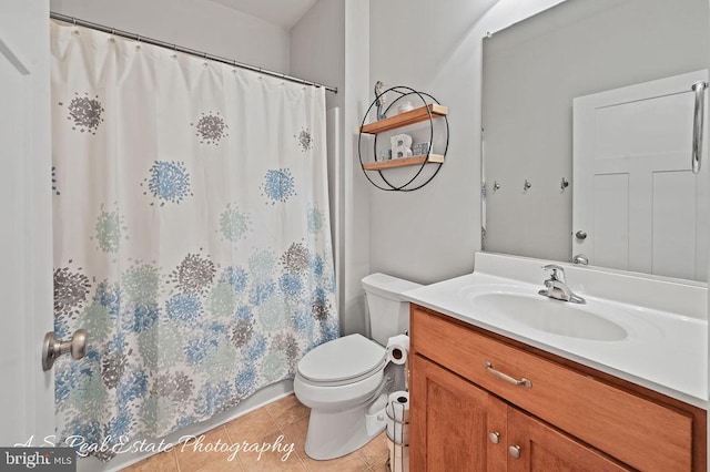 bathroom featuring tile patterned floors, a shower with curtain, vanity, and toilet