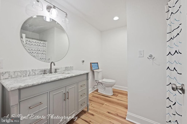 bathroom with a shower with curtain, vanity, toilet, and wood-type flooring