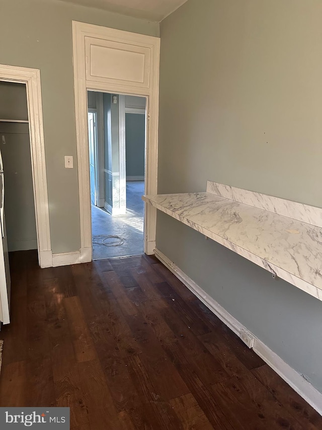 hallway with dark wood-type flooring