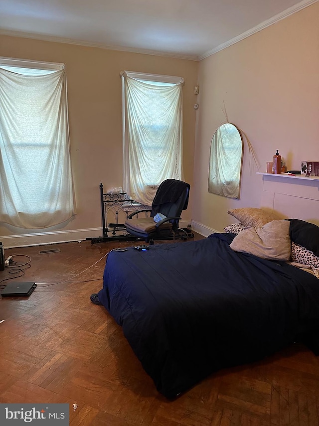 bedroom with crown molding and parquet flooring