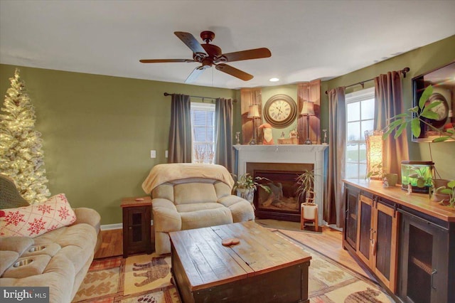 living room featuring ceiling fan and light hardwood / wood-style flooring