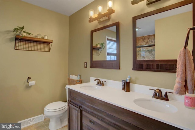 bathroom featuring tile patterned flooring, vanity, and toilet