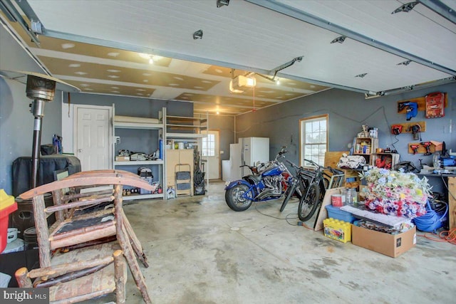 garage with white fridge and a garage door opener