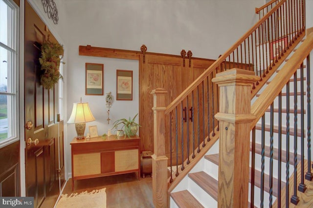 staircase with hardwood / wood-style floors