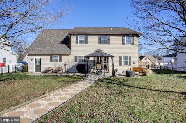 rear view of property with a gazebo and a lawn