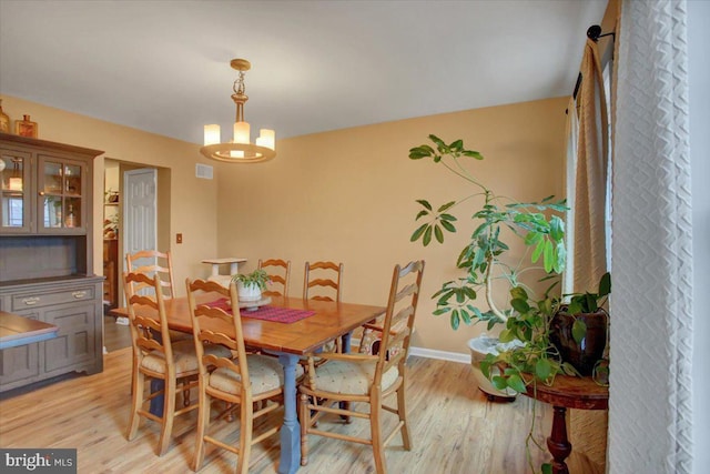 dining room featuring a notable chandelier and light hardwood / wood-style floors