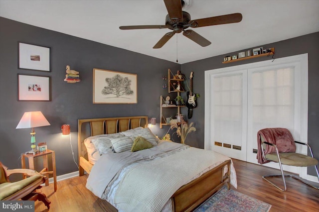 bedroom with hardwood / wood-style floors and ceiling fan