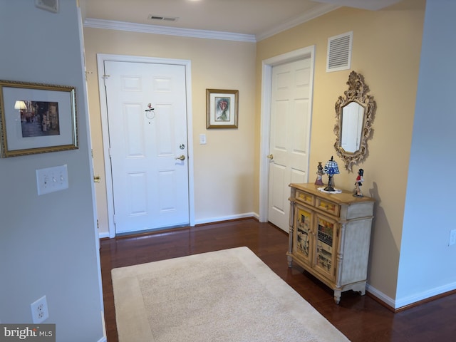 foyer entrance with dark hardwood / wood-style flooring and crown molding