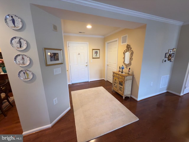 foyer featuring dark wood-type flooring and ornamental molding