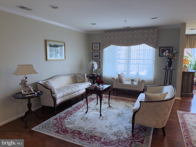 living room featuring dark hardwood / wood-style flooring, crown molding, and a healthy amount of sunlight