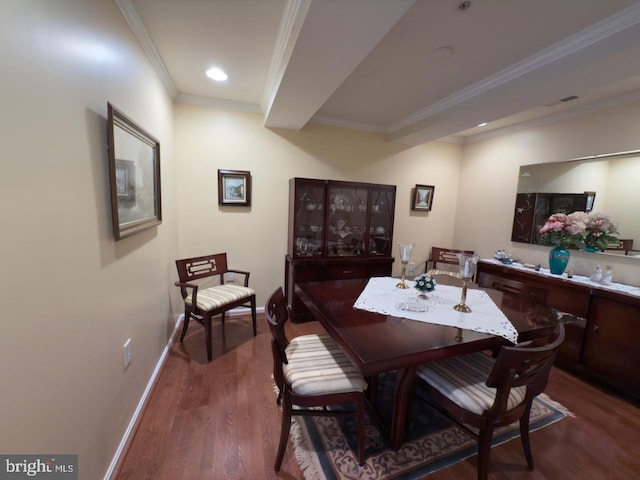 dining area featuring crown molding and dark hardwood / wood-style floors