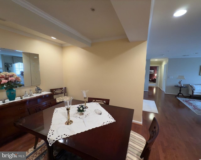 dining area featuring dark hardwood / wood-style flooring and ornamental molding