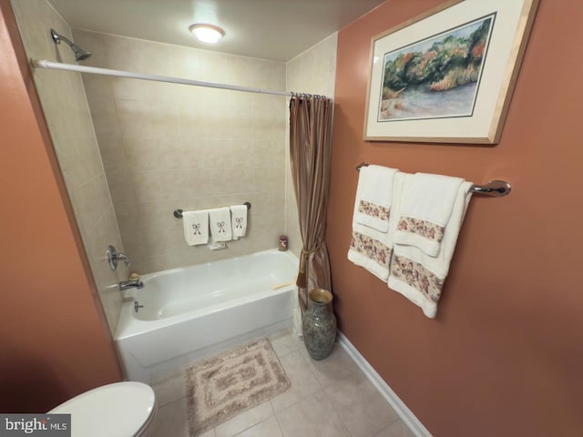 bathroom with toilet, shower / bath combo, and tile patterned floors