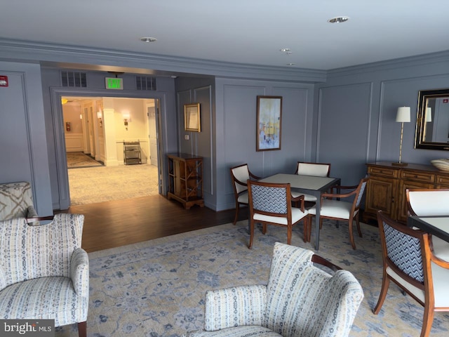 living room with light hardwood / wood-style flooring and ornamental molding