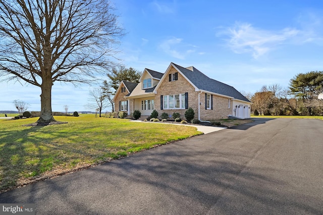 view of front of property with a front yard and a garage