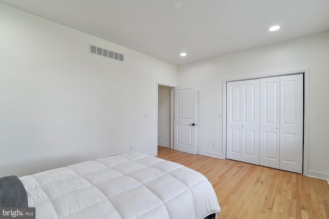 bedroom featuring light hardwood / wood-style flooring and a closet