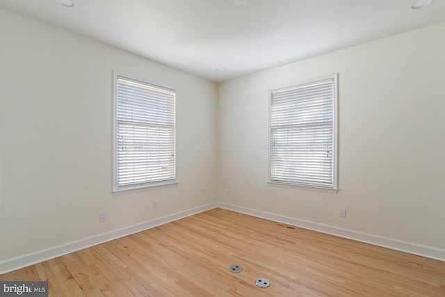 unfurnished room with light hardwood / wood-style floors