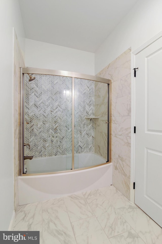 bathroom with bath / shower combo with glass door