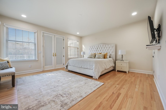 bedroom with light wood-type flooring and multiple windows