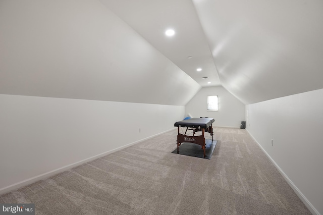 playroom featuring light colored carpet and vaulted ceiling