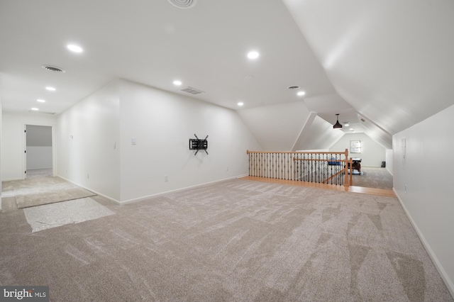 bonus room with ceiling fan, lofted ceiling, and light carpet