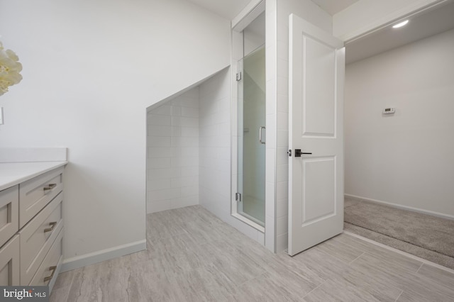 bathroom with vanity and a shower with shower door