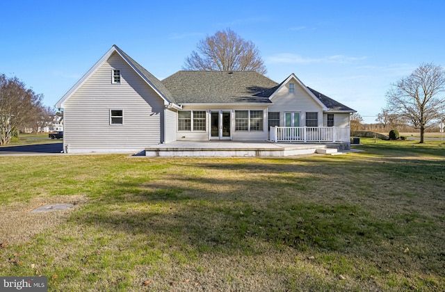 back of house featuring a wooden deck and a yard