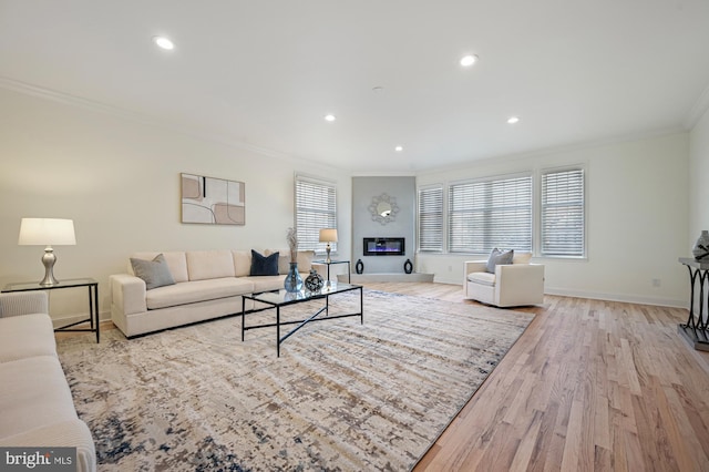 living room featuring light wood-type flooring and ornamental molding