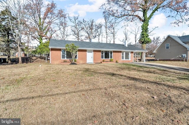 ranch-style house featuring a front yard and a carport