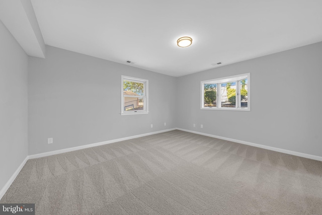 carpeted spare room with a healthy amount of sunlight