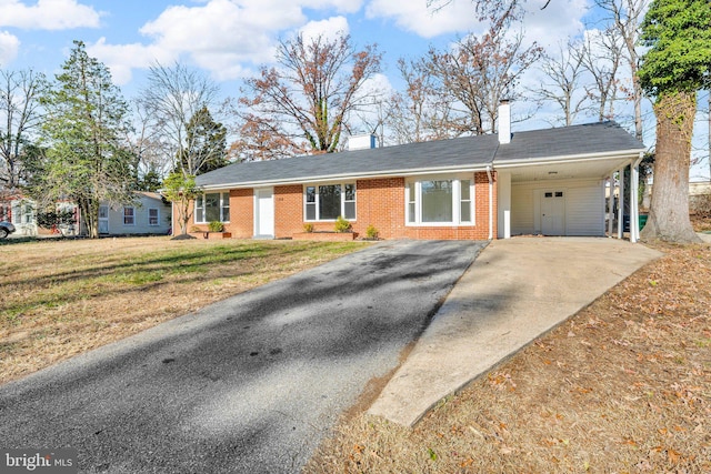 ranch-style home with a front yard and a carport