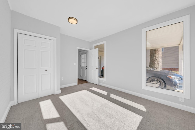 unfurnished bedroom featuring carpet flooring and a closet