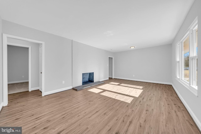 unfurnished living room featuring light hardwood / wood-style floors