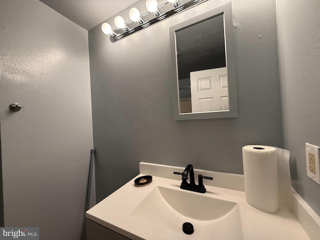 bathroom with vanity and a textured ceiling