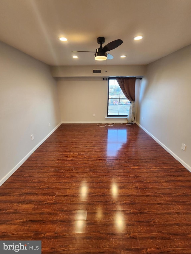 empty room featuring dark hardwood / wood-style floors and ceiling fan